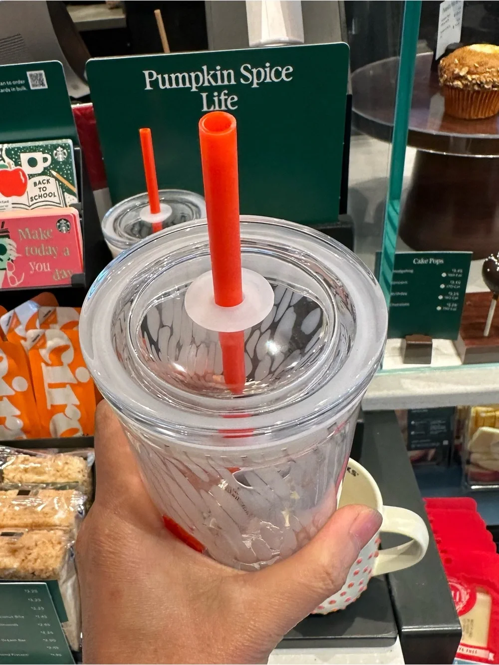 Starbucks 16-ounce PSL glass cold cup pumpkin detail with a matching straw.